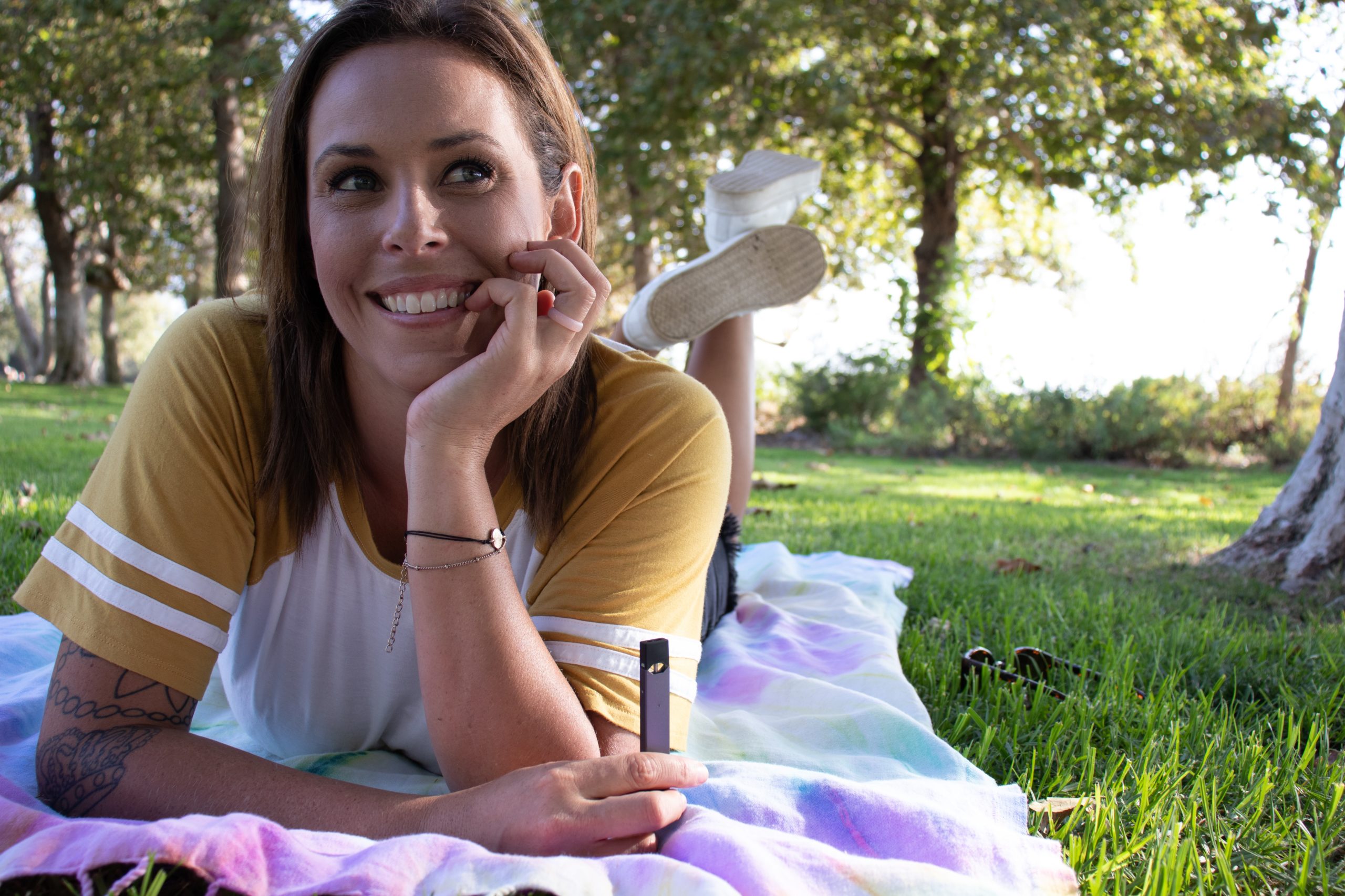 Lady vaping on grass